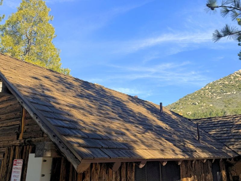 Crew tearing off an old gravel built-up roof before installing a new TPO membrane and solar array in San Diego